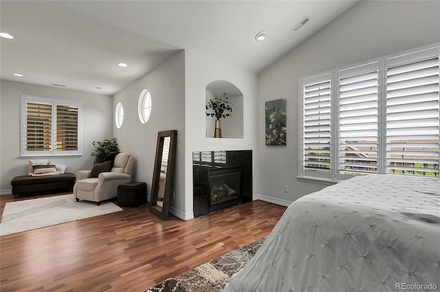 10152 Bluffmont Ln, Lone Tree, CO 80124 - bedroom with wood finished floors, recessed lighting, a glass covered fireplace, and lofted ceiling