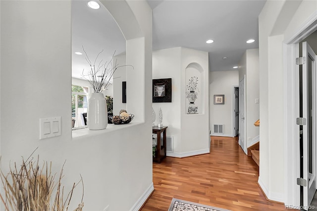 10152 Bluffmont Ln, Lone Tree, CO 80124 - corridor with wood finished floors, recessed lighting, and arched walkways