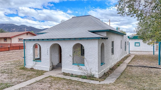 view of side of home with a mountain view