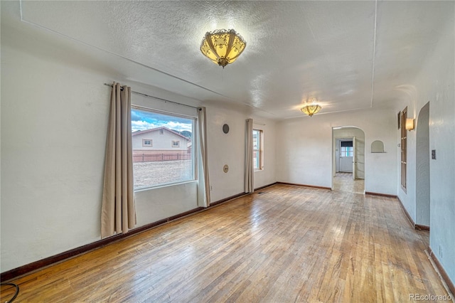 empty room featuring hardwood / wood-style floors and a textured ceiling