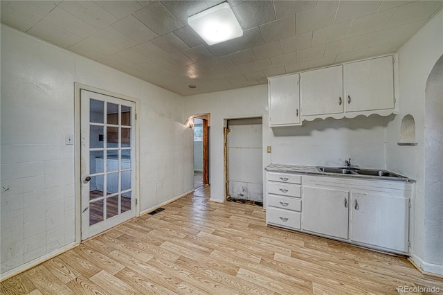 kitchen featuring sink, white cabinetry, and light hardwood / wood-style flooring