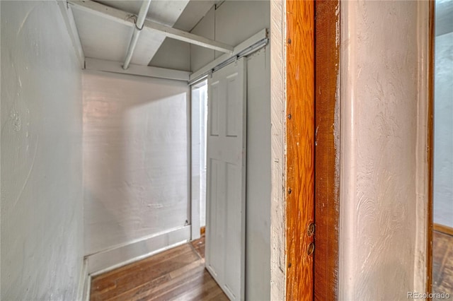 corridor with hardwood / wood-style flooring