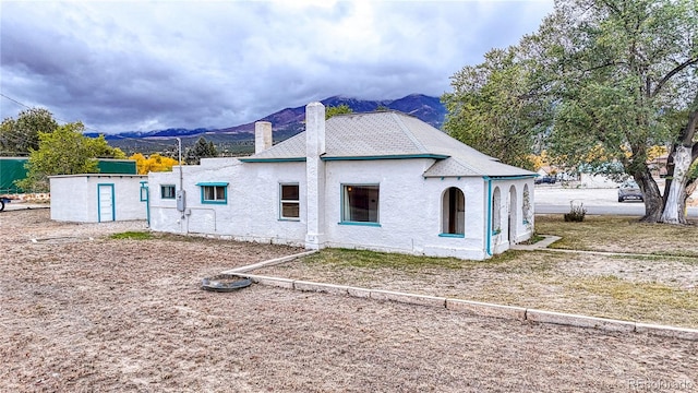 view of property exterior with a mountain view