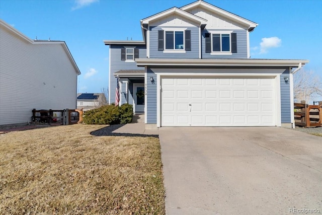 traditional-style home featuring driveway, an attached garage, fence, a front lawn, and board and batten siding