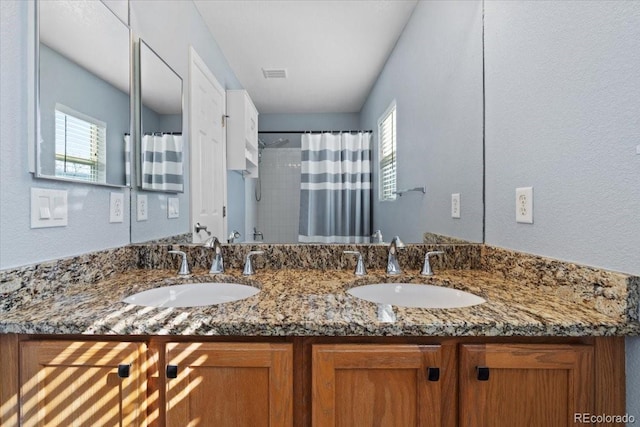 full bathroom featuring a wealth of natural light, visible vents, and a sink