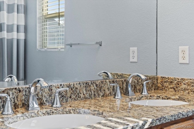 interior details featuring double vanity and a sink