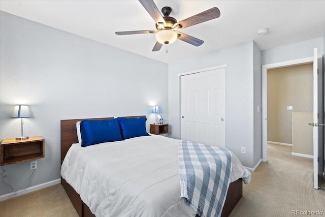 bedroom with carpet, baseboards, and a closet