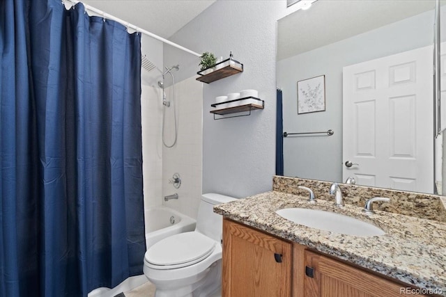 bathroom with shower / bath combination with curtain, a textured wall, vanity, and toilet