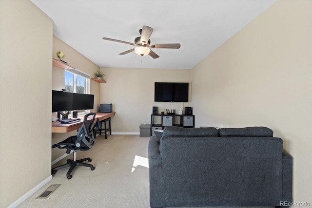 carpeted office with visible vents, ceiling fan, and baseboards