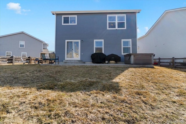 back of property featuring a patio area, fence, and a yard