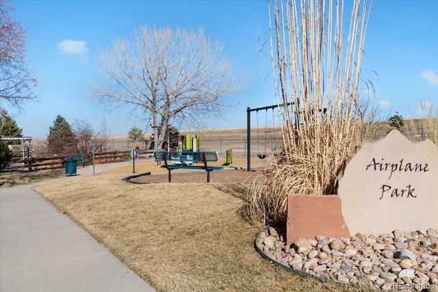 view of community with a yard and fence