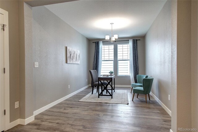 4090 Forever Cir, Castle Rock, CO 80109 - dining room featuring a textured wall, a chandelier, wood finished floors, and baseboards