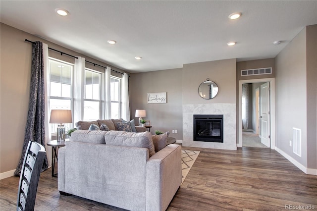 4090 Forever Cir, Castle Rock, CO 80109 - living area with a tiled fireplace, baseboards, wood finished floors, and recessed lighting