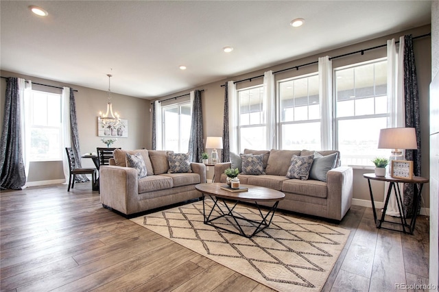 4090 Forever Cir, Castle Rock, CO 80109 - living area featuring a chandelier, baseboards, light wood finished floors, and recessed lighting