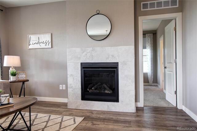 4090 Forever Cir, Castle Rock, CO 80109 - living room featuring wood finished floors, baseboards, and a tiled fireplace