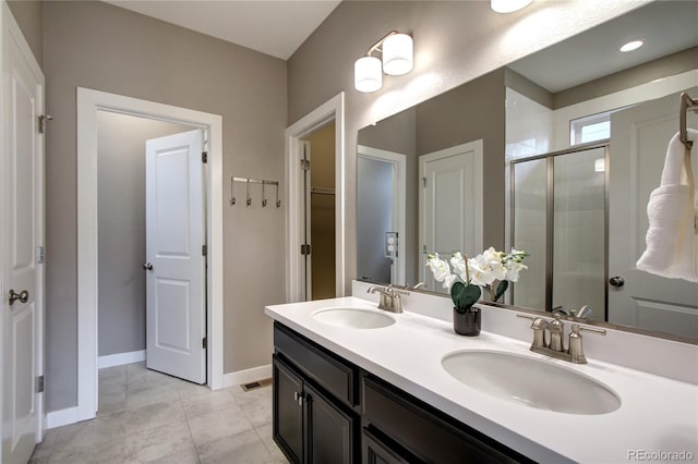 4090 Forever Cir, Castle Rock, CO 80109 - full bath with a shower stall, double vanity, baseboards, tile patterned floors, and a spacious closet