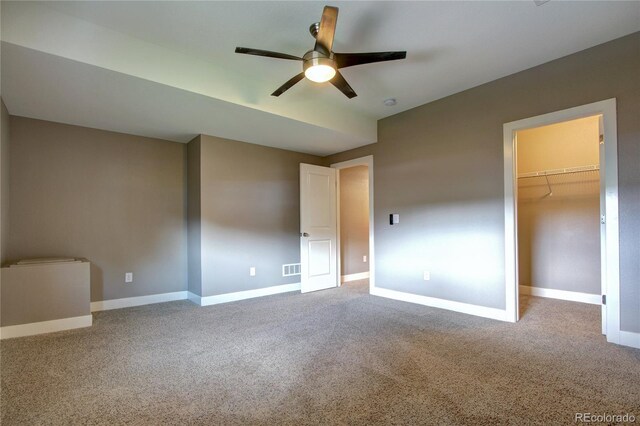 4090 Forever Cir, Castle Rock, CO 80109 - unfurnished bedroom with carpet floors, baseboards, a walk in closet, ceiling fan, and a closet