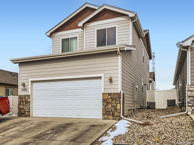 view of front facade featuring central AC and a garage