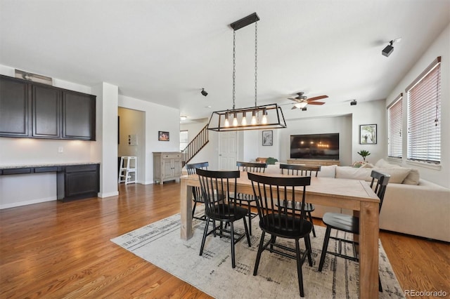 dining area with dark hardwood / wood-style floors and ceiling fan