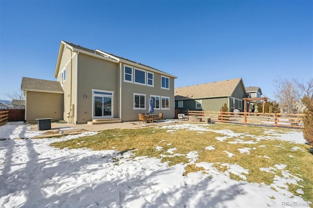 snow covered property with a patio area