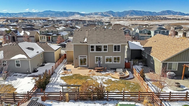 snowy aerial view featuring a mountain view