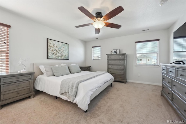 bedroom with light colored carpet and ceiling fan