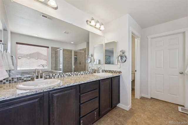 bathroom with walk in shower, vanity, toilet, and tile patterned flooring