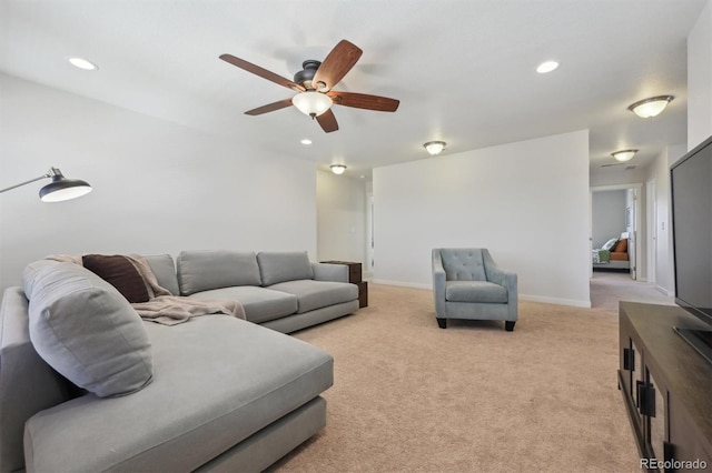 carpeted living room featuring ceiling fan