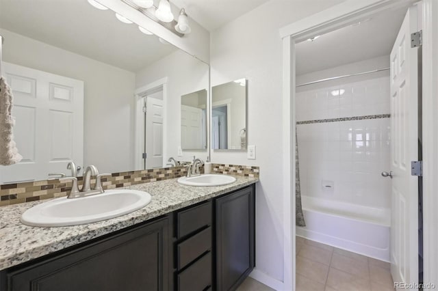 bathroom with tiled shower / bath, tile patterned floors, decorative backsplash, and vanity