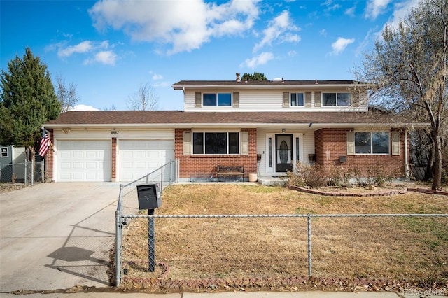 traditional home featuring a fenced front yard, a garage, brick siding, driveway, and a front lawn