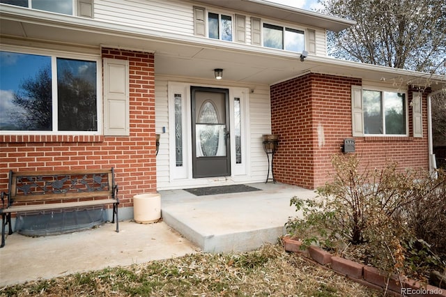 property entrance with brick siding