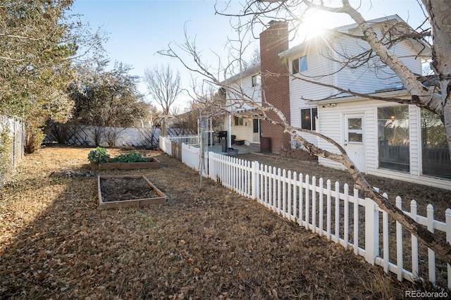 view of yard with a fenced backyard and a vegetable garden