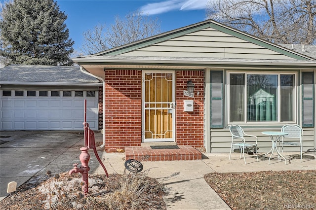 7005 S Ash Cir, Centennial, CO 80122 - view of front facade featuring concrete driveway, brick siding, and an attached garage