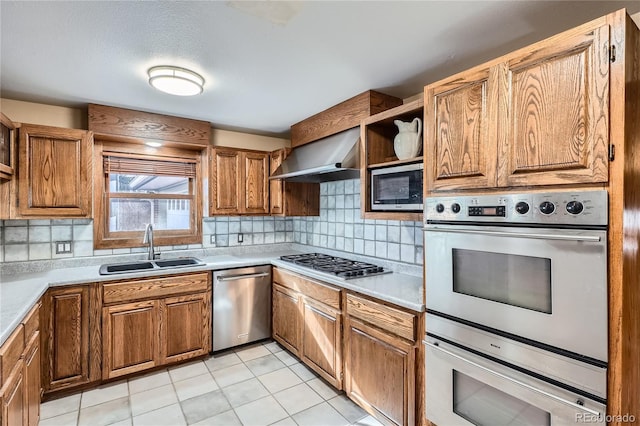 7005 S Ash Cir, Centennial, CO 80122 - kitchen featuring a sink, brown cabinetry, open shelves, wall chimney exhaust hood, and appliances with stainless steel finishes
