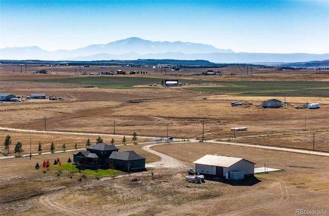 birds eye view of property with a mountain view and a rural view