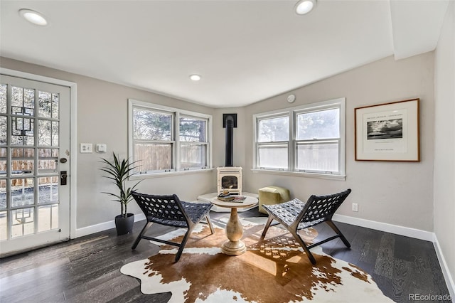 living area with recessed lighting, a wood stove, baseboards, and dark wood-style flooring