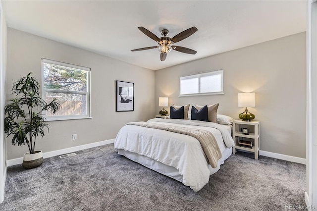 bedroom with carpet, multiple windows, visible vents, and baseboards