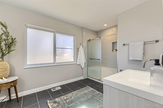 full bathroom with visible vents, a shower with shower door, a sink, baseboards, and tile patterned floors