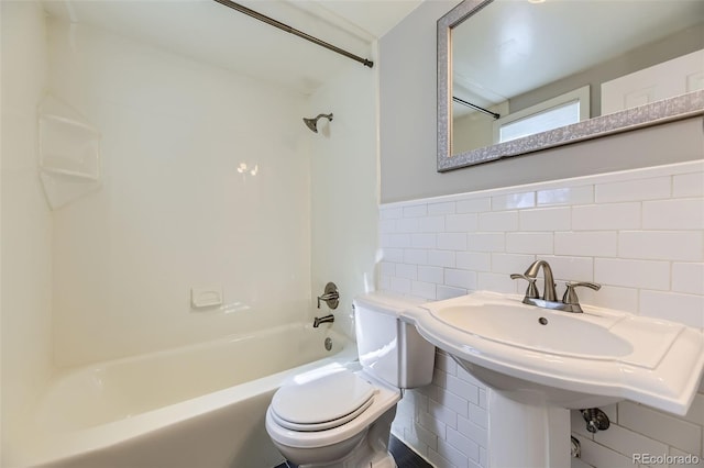 bathroom featuring toilet, a wainscoted wall, tile walls, and shower / bathing tub combination