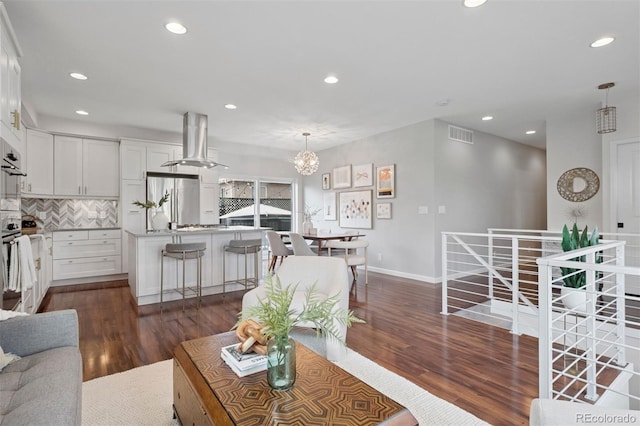 2945 E 26th Avenue Parkway, Denver, CO 80205 - living room featuring dark wood-type flooring, recessed lighting, a chandelier, and baseboards