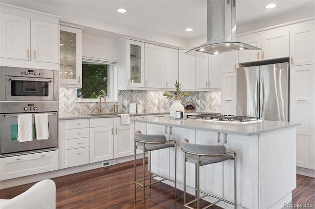 2945 E 26th Avenue Parkway, Denver, CO 80205 - kitchen featuring appliances with stainless steel finishes, island range hood, a sink, light countertops, and a kitchen island