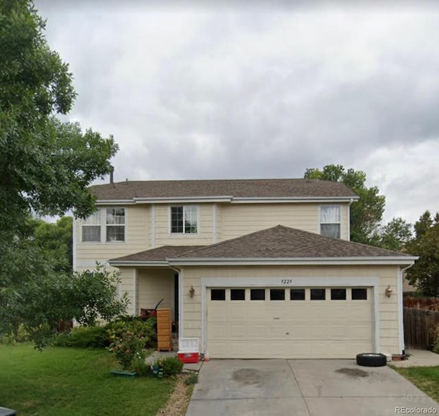 view of front property with a garage and a front yard