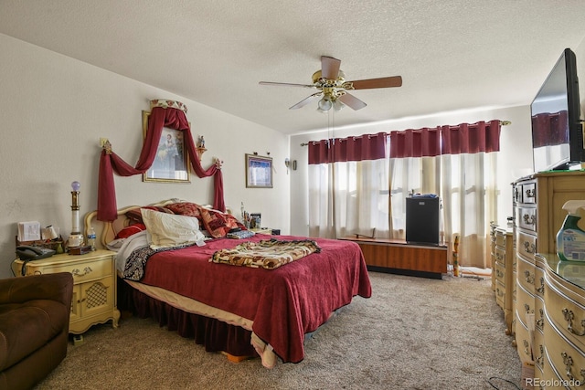 carpeted bedroom featuring a textured ceiling and ceiling fan