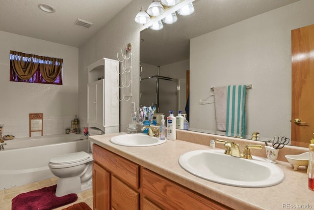 full bathroom with vanity, tile patterned floors, toilet, a textured ceiling, and independent shower and bath