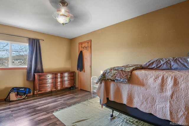 bedroom with ceiling fan and dark wood-type flooring