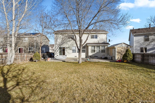 rear view of property with a shed, a patio area, and a lawn