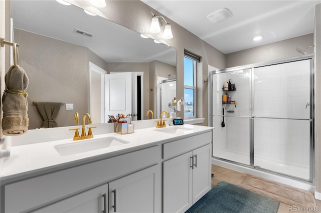 bathroom featuring vanity, tile patterned flooring, and walk in shower