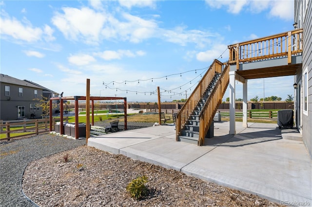 view of jungle gym with a patio and a wooden deck