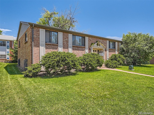 1410 S Ash St, Denver, CO 80222 - split foyer home featuring central AC, a front lawn, and brick siding