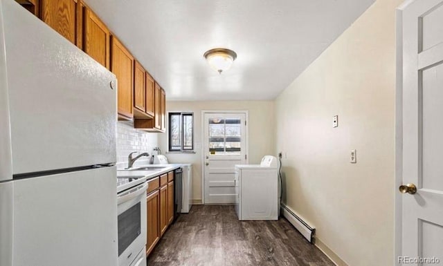 1410 S Ash St, Denver, CO 80222 - kitchen featuring washer / dryer, white appliances, baseboard heating, brown cabinets, and a sink